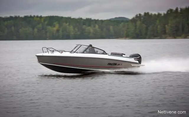 A Falcon 18ft boat speeds across a lake, surrounded by green trees and a cloudy sky. Visible text reads "FALCON 18.